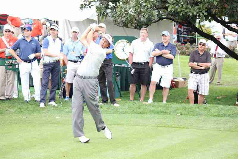 Phil Mickelson tees off at the Pro-am charity event at Bay Hill with professional and amateur golfers.