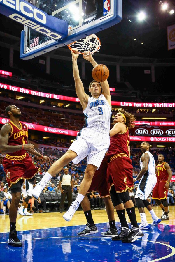 Orlando Magic Center Nikola Vucevic (9) dunks during first-quarter action of a preseason game against the Cleveland Cavaliers at Amway Center.