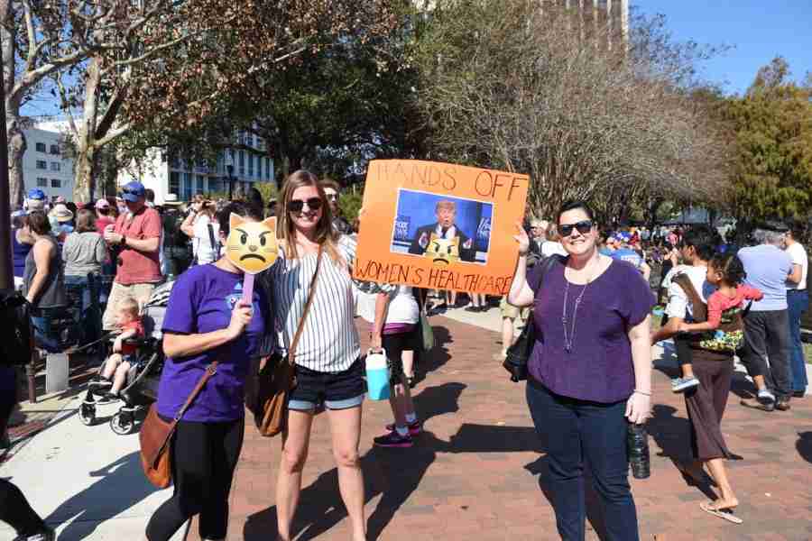 April O’Neal (right) and friends proudly marched with their sign sending a message to Donald Trump, “hands off women’s healthcare.