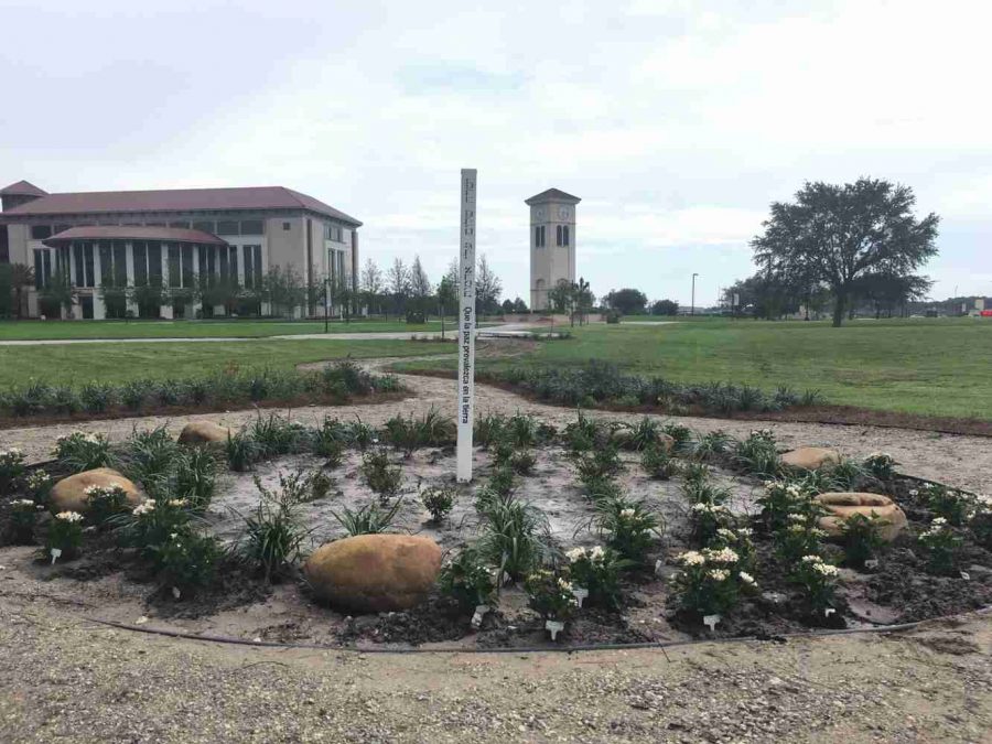 Osceola Campus Peace Pole surrounded by 49 flowers.