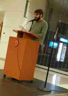 Ryan Tullis, coffeehouse MC, reciting a Sylvia Plath poem to warm up the audience and inspire others to come up and read.