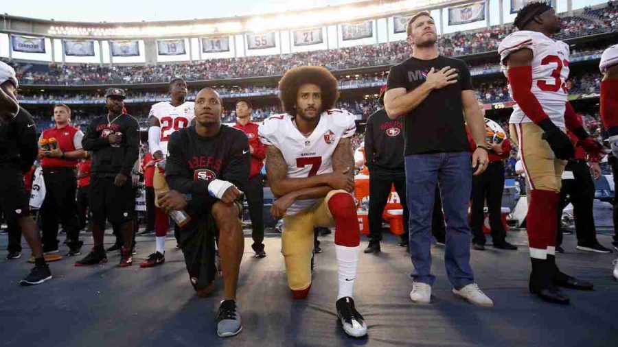Colin Kaepernick , then of the San Francisco 49ers, takes a knee during the national anthem.