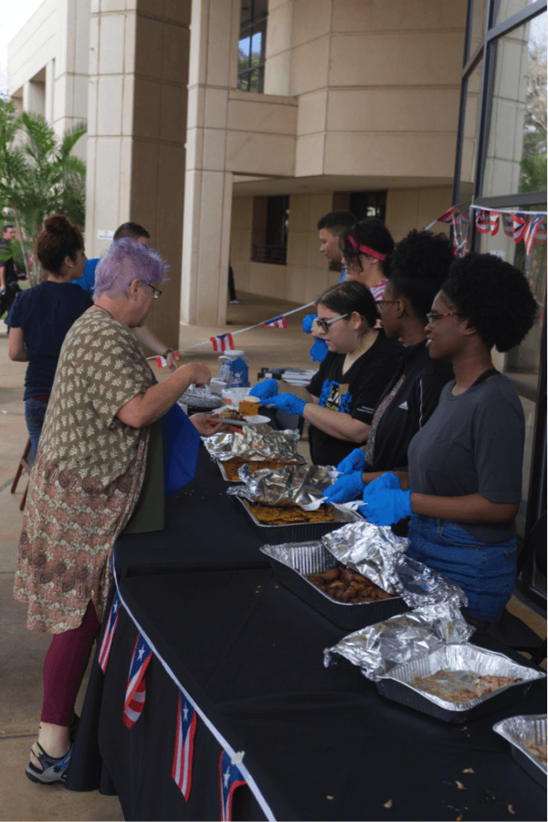 Phi Theta Kappa officers serve authentic Puerto Rican food to students and staff.