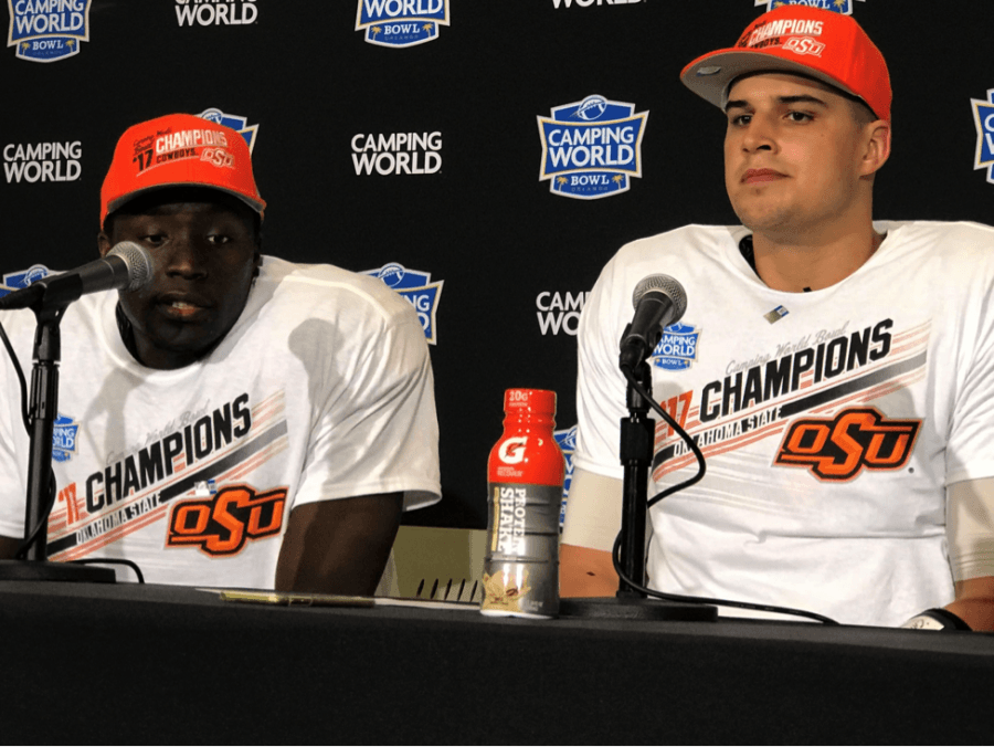 Oklahoma State’s James Washington Jr. (left) and 2017 Camping World Bowl most valuable player Mason Rudolph (right) speak to the media about the next stage of their careers.