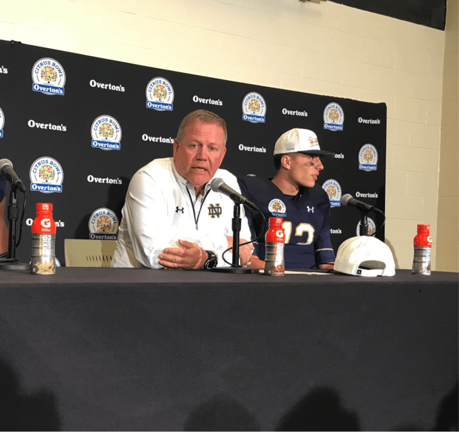 Notre Dame Head Coach Brian Kelly (left) and quarterback Ian Book speak to the media after the Citrus Bowl.
