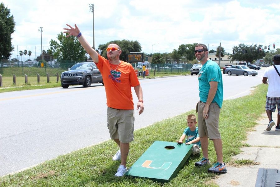 Fans tailgate at Camping World Stadium before college football kicks