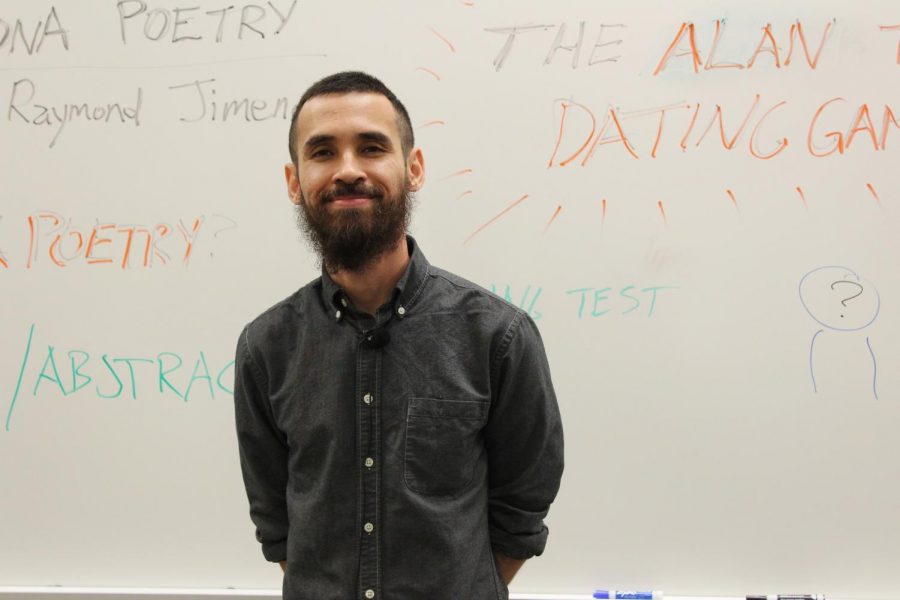 Raymond Jimenez uses the white board in Building 8, Room 101 to inform attendees about poetry.