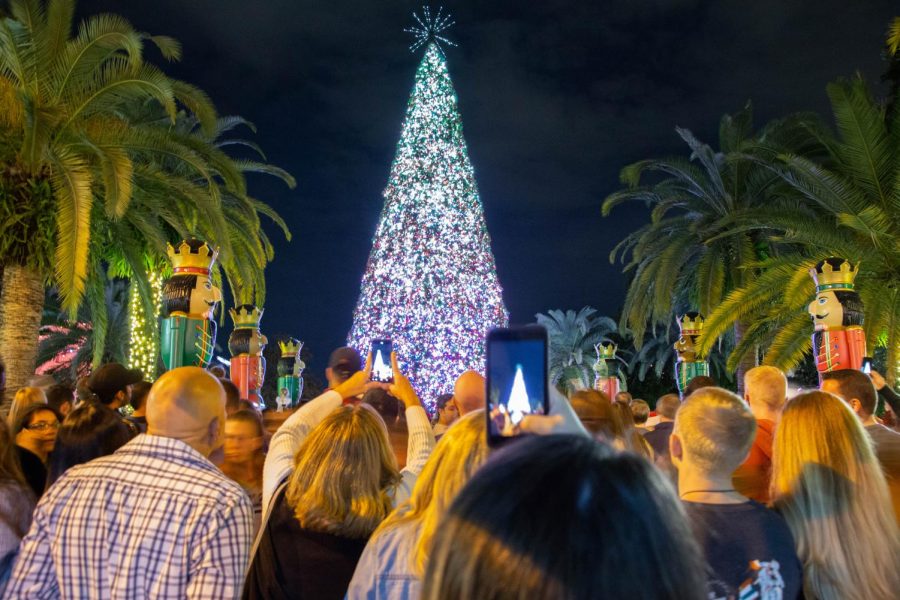 Attendees take photos of Lake Eola Christmas Tree