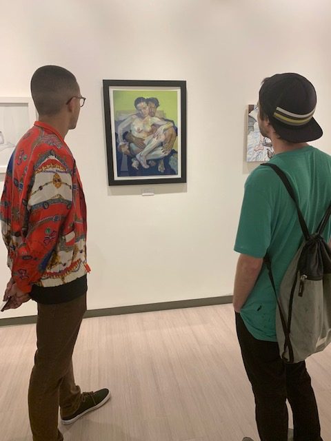 Two students gaze at one of Luceys pieces at Thursdays exhibit opening.