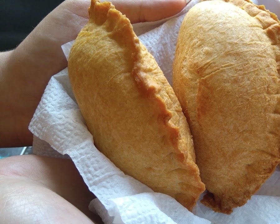 Empanadas being served on a paper towel. 