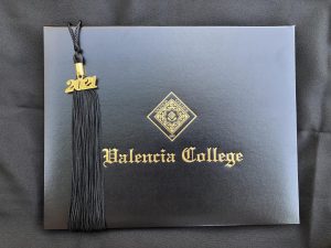 Valencia College student diploma and tassel that has been mailed to students in a graduation box.
