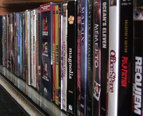 Movies displayed on a shelf. 