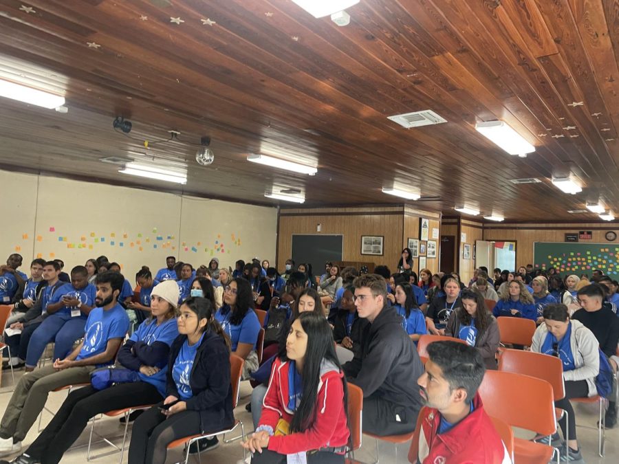 Dr. LaDonna speaks at the conference while students watch. 