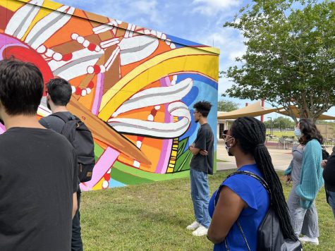 Students admire the new art mural located on Osceola Campus Bldg C. 