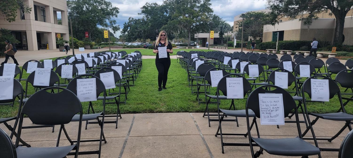 Valencia East Campus Counselor Dr. Jocelyn Morales poses at the visual exhibit representing the number of suicides happening each day in the U.S. 