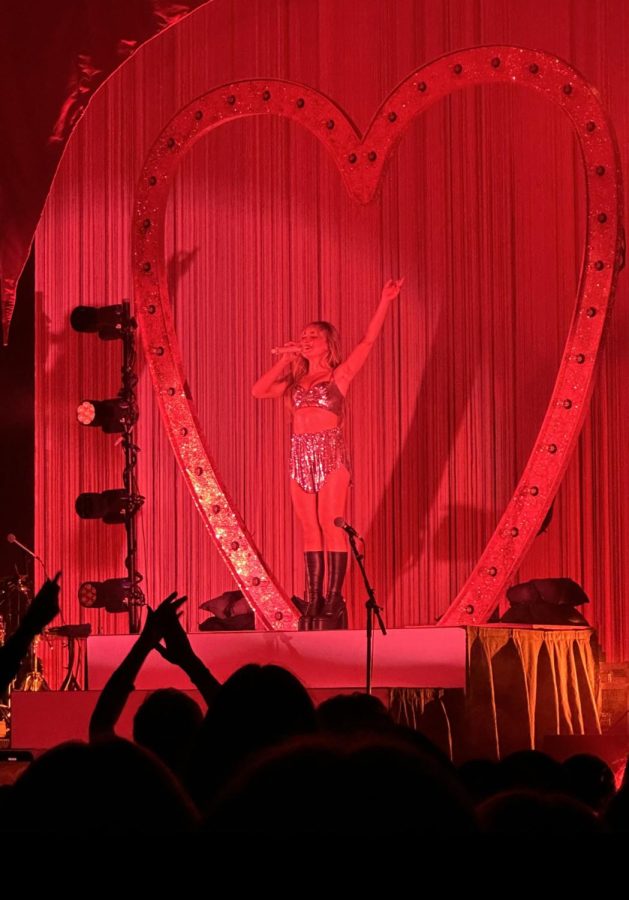 Sabrina Carpenter performs in red light with a heart-shaped backdrop as part of the final show of the ‘Emails I Can’t Send’ tour. Hard Rock Orlando. 