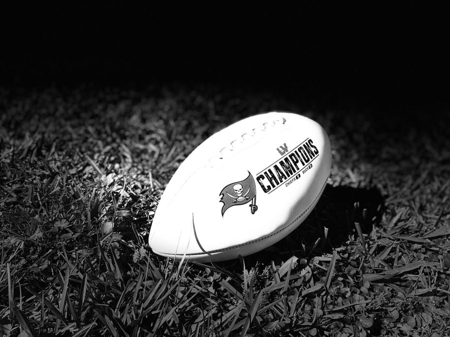 Football with Buccaneer team logo and Championship displayed. 