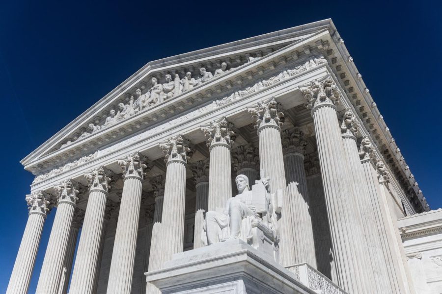 US Supreme Court Building viewed from underneath the main courtyard and statue. 