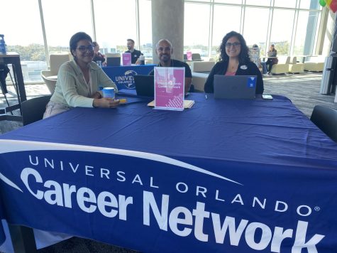 (Left to right) Valencia College student Daniela Giron Rumie, 21, Communicatiosn, talks about benefits and career options with Universal Orlando Career Network Specialists Osmar Marrero and Emily Tardibuono at the Universal Orlando Day on February 14. 