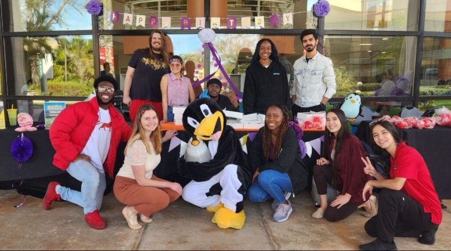 East Campus Student Development Student Leaders pose with Pooky at the 11-Year Celebration of Pooky's Pantry. 