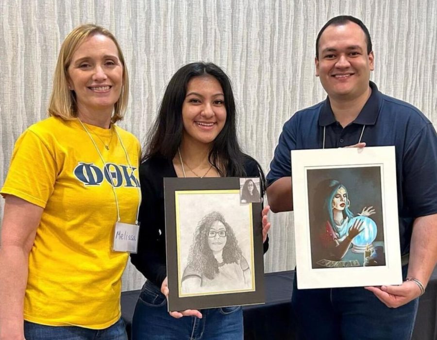 Phi Theta Kappa Chapter Members pose with art