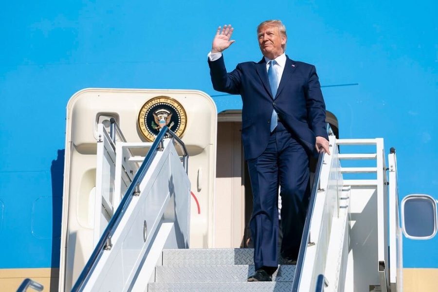 Trump waves to onlookers from Air Force One during his time as President of the United States. 