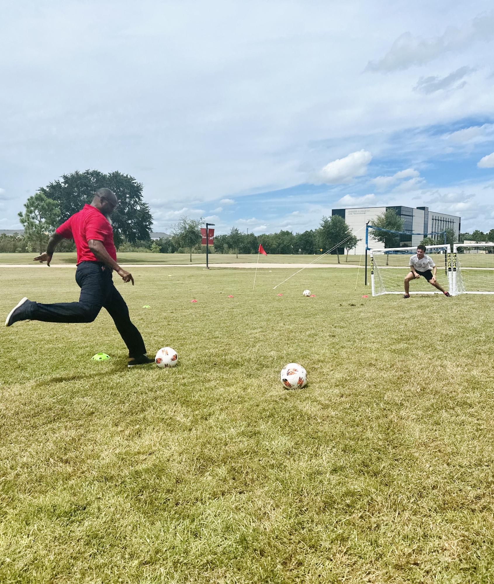 Provost Lancelot Gooden sets up for a kick at the August 29 Sports Day on Osceola Campus. 