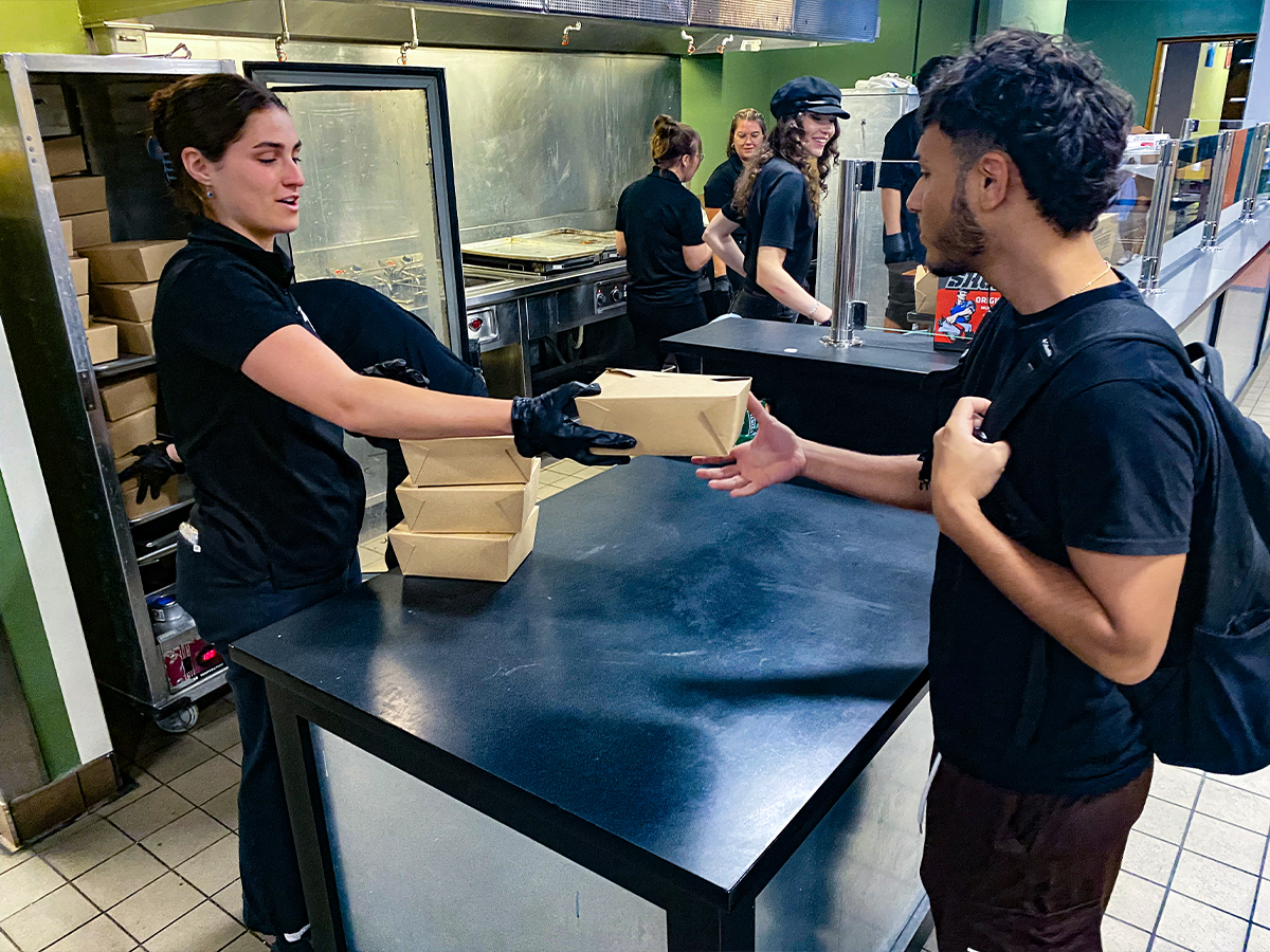 Gabriel Javier, 21, Business Admin, receives a chicken meal from 4Rivers at the East Campus on September 11. 