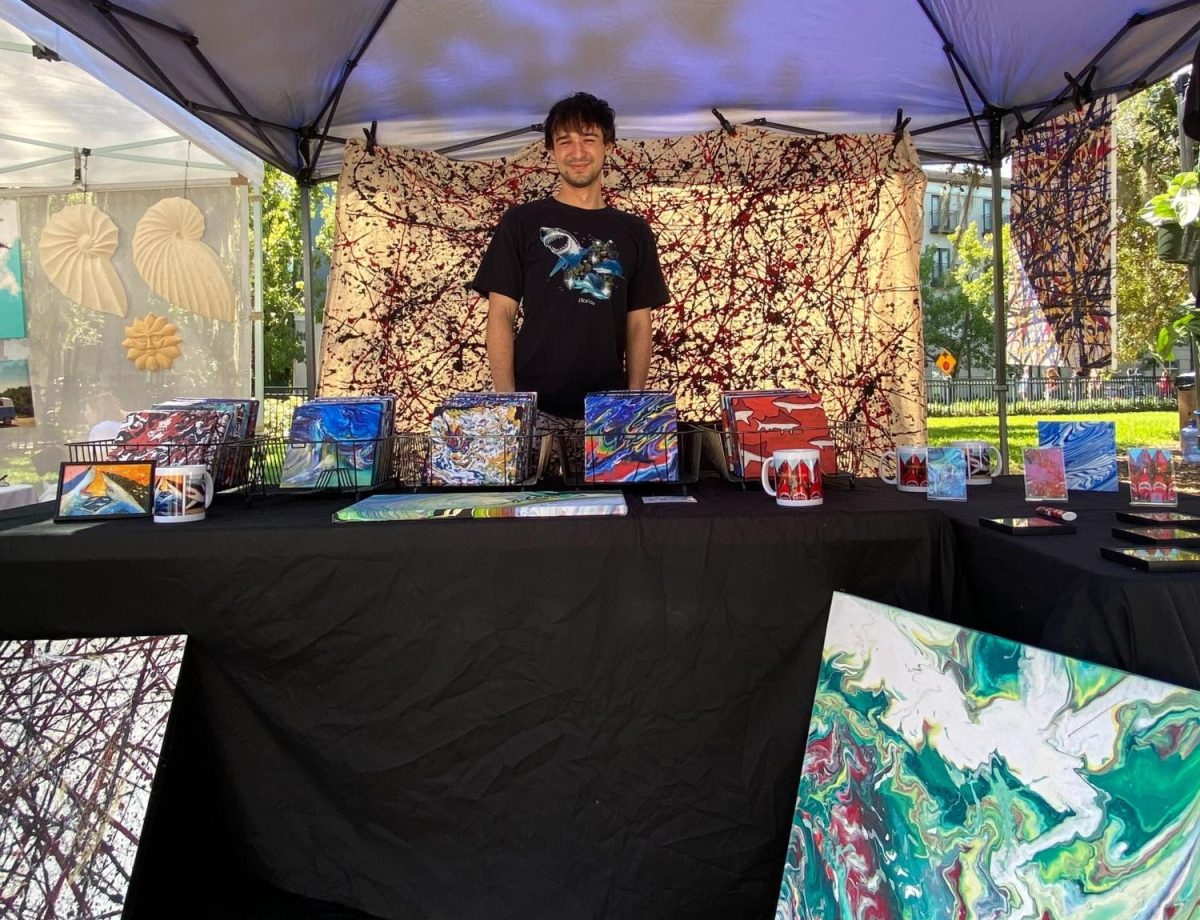 Jason Hoogsvort presenting his shark and abstract artwork at the Orlando Farmers Market on Lake Eola.