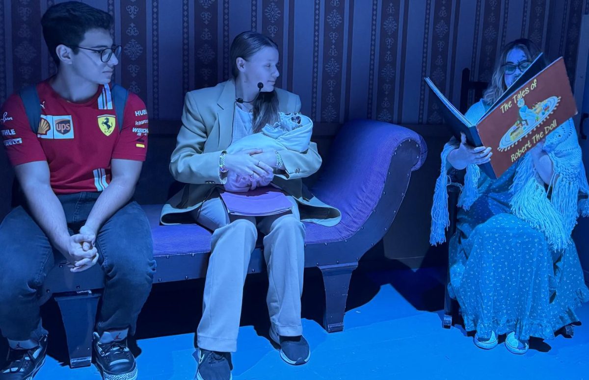 Karim Flayhan, 17 Health Sciences, sits in the Child's Room while a performer reads him a story. 