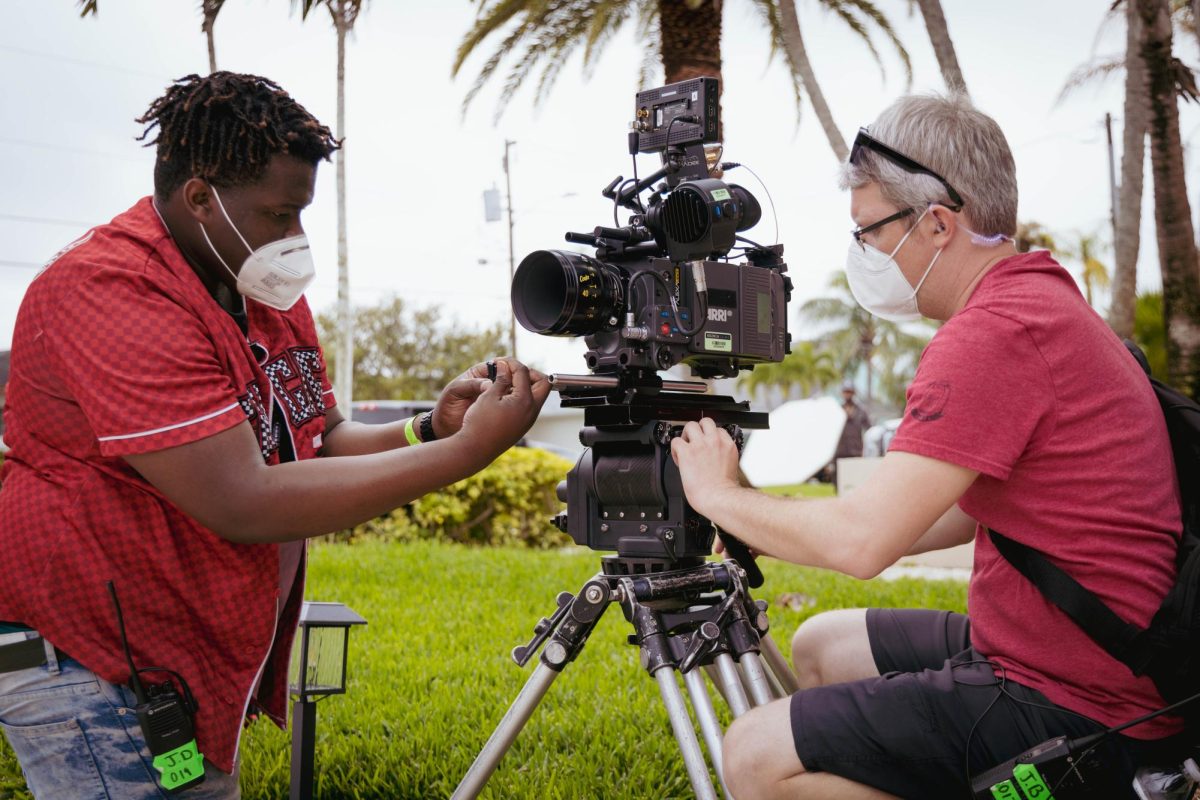 Student Jerry Doralus, pictured left, as 2nd AC, aids 1st AC. 