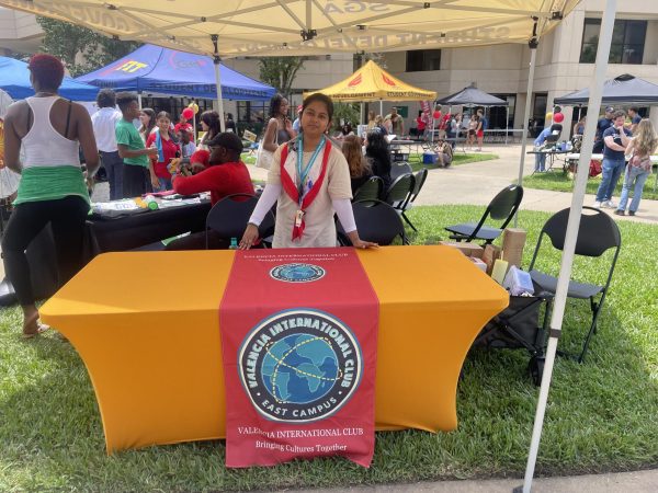 International Club Vice President, Tasneem Shahnewaz, welcomes students to the International Club table at the East Campus Welcome Back event. 