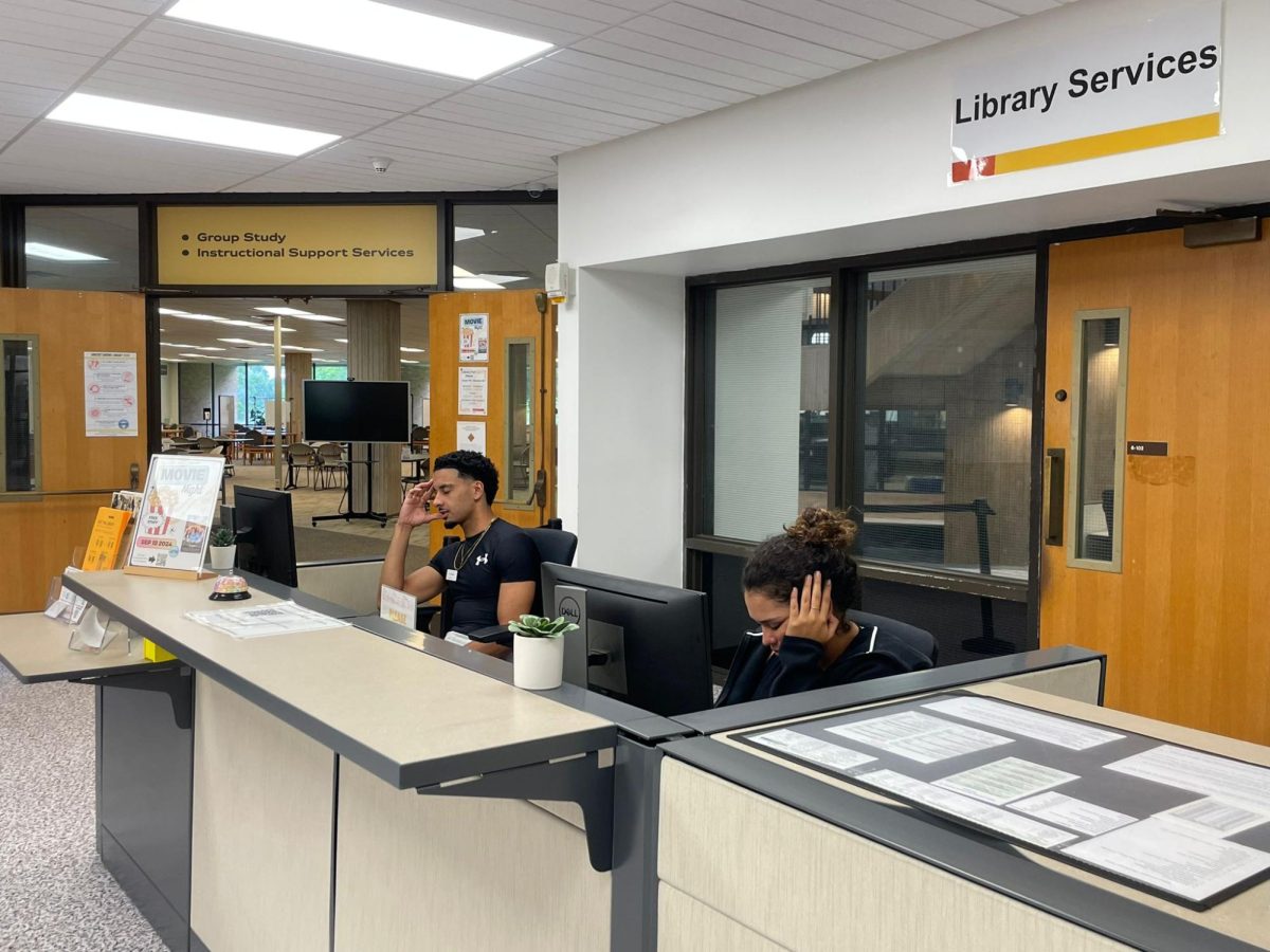 Student workers Loic Legarde and Maria Lucia de la Oz at Valencia College West Campus Library. Both are managing their worries while balancing the demands of studying and working.