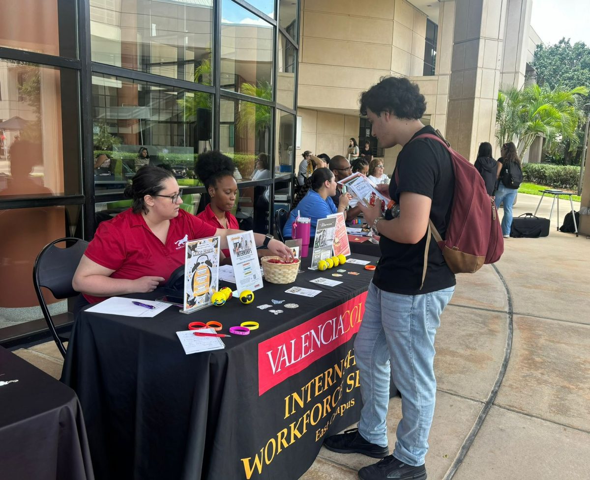 First year student, Francisco Albano, inquires about opportunities at
the Internship and Workforce Services table at Valencia College’s Club and
Resource Fair.
