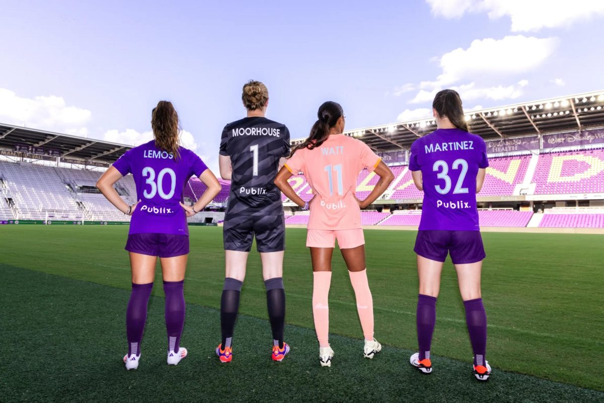 Orlando Pride players Ally Lemos, Anna Moorhouse, Ally Watt, and Brianna Martinez at Inter & Co stadium showcase the team’s new jersey, sponsored by Publix, in a promotional photo ahead of Fan Appreciation Night.