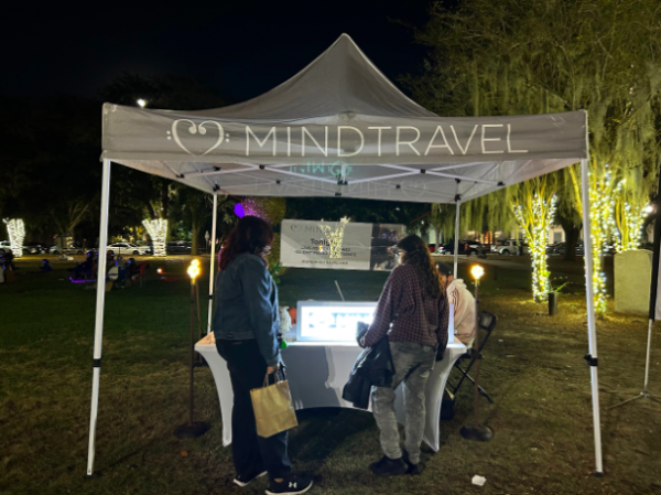 Concert goers pick up headphones for the MindTravel silent piano concert at Lake Eola.